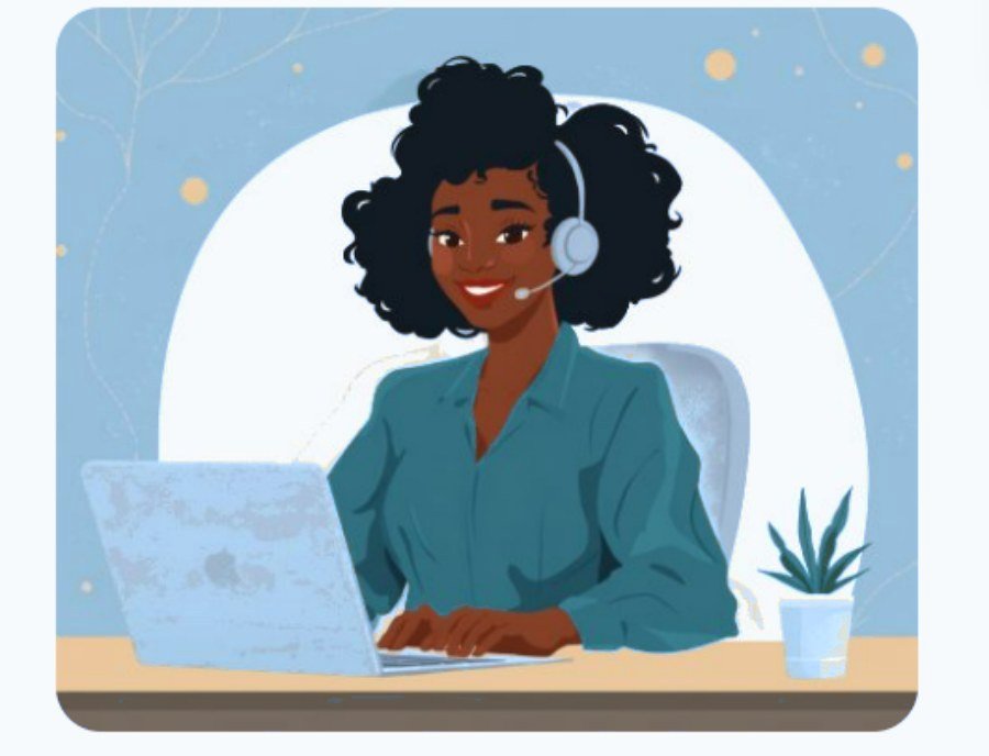 A Ghanaian care coordinator wearing a headset, smiling at her laptop